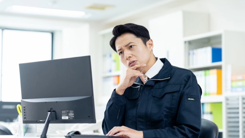 HDDデータ取り出しの限界に直面するビジネスマン。重度の物理障害など、自力で復旧できないケースや、すべてのデータを取り出せないリスクを慎重に判断している様子