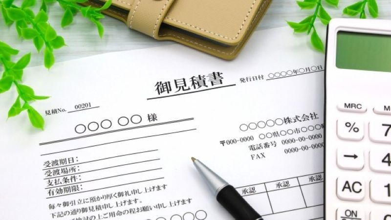 データ復旧の費用を確認するための見積書と電卓。不当な追加請求を避けるための慎重な確認を想起させる。